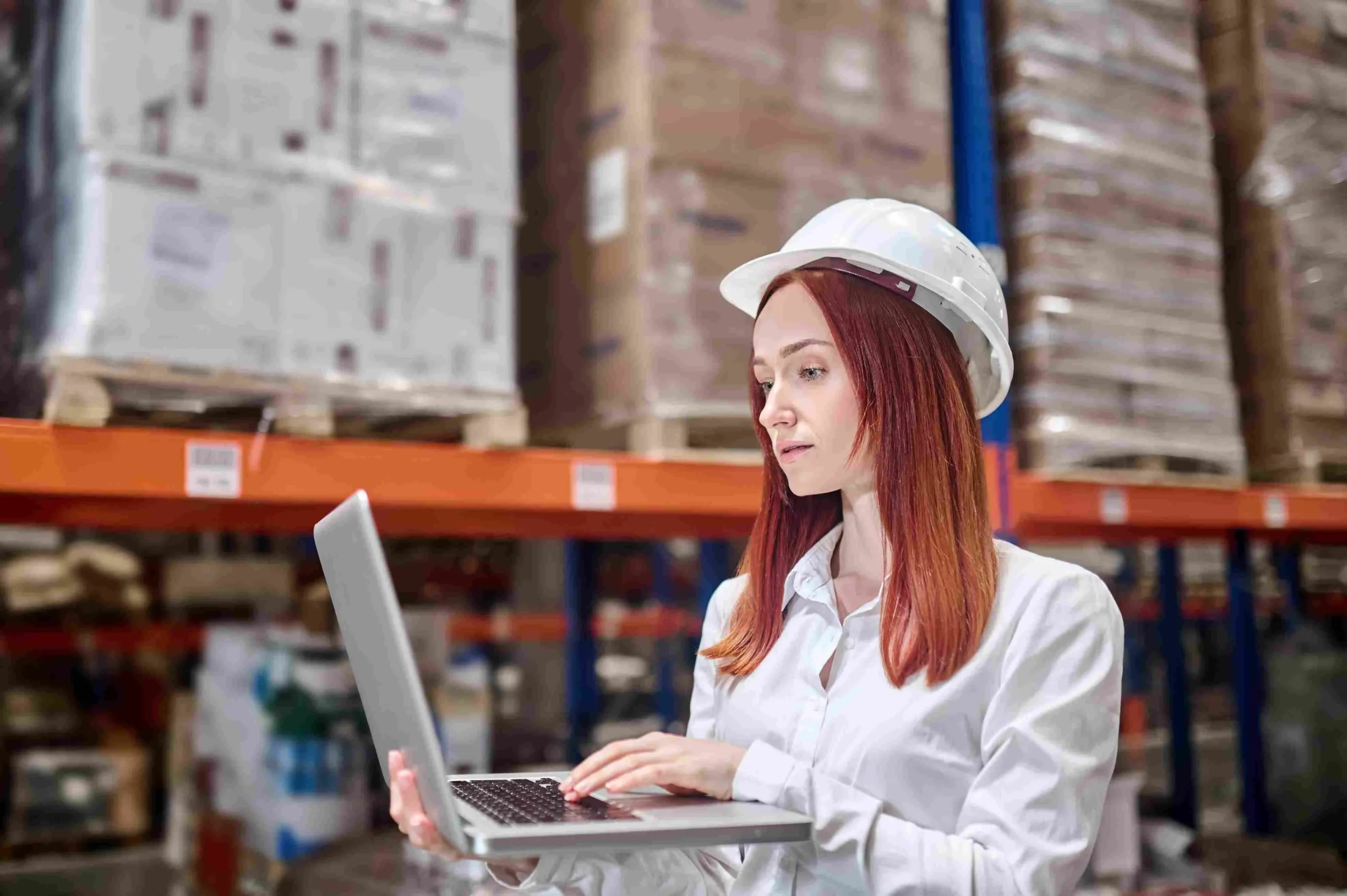 woman-helmet-holding-open-laptop-working_compressed